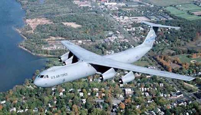 C-141%20Starlifter%20over%20coastal%20town_jpg